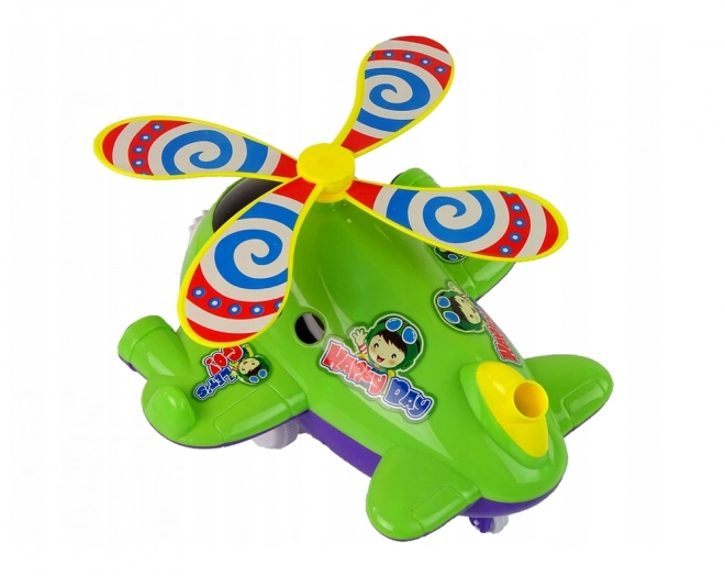 Avion pousseur vert avec longue canne et clochette