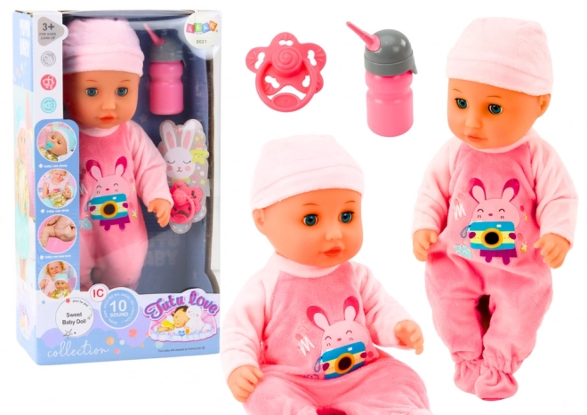 Poupée bébé avec vêtements roses et effets sonores