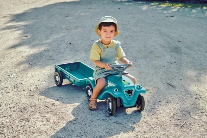 Voiture à pousser avec remorque en turquoise